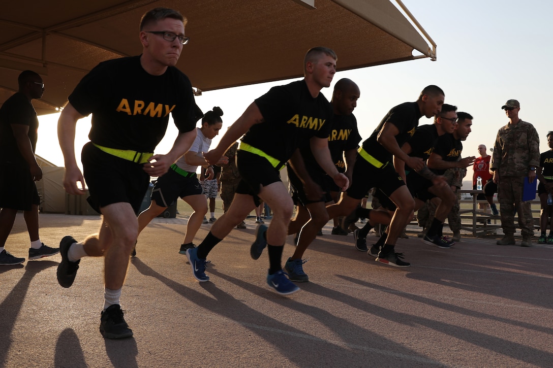 Deployed U.S. service members begin a run for a fitness test.