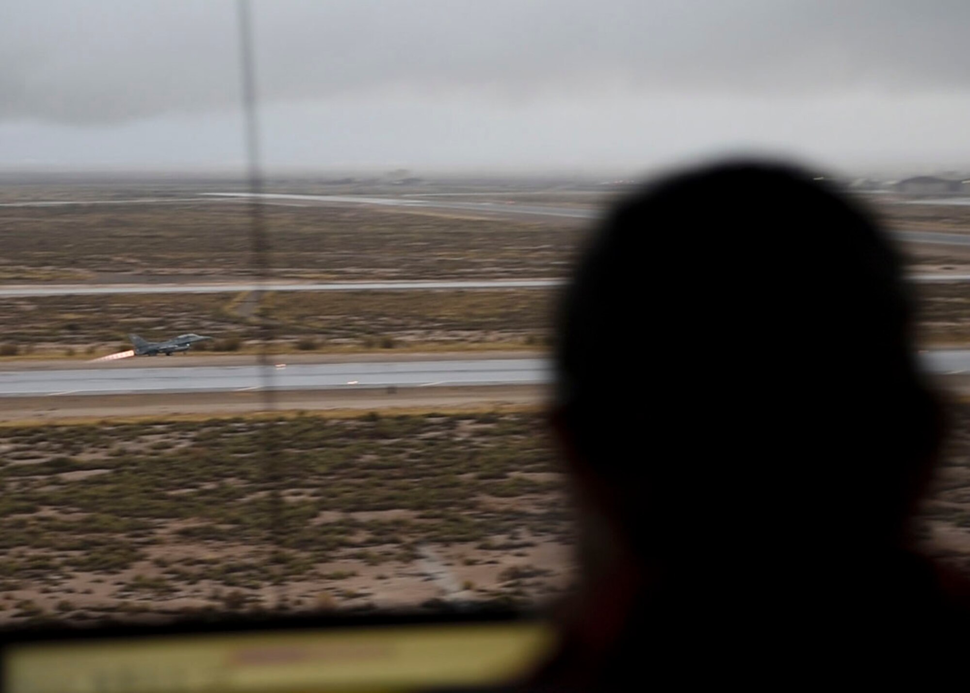 A 54th Operations Support Squadron air traffic controller observes an F-16 Fighting Falcon take off, Dec. 18, on Holloman Air Force Base, N.M. Before an F-16 can take off or land they must be in contact with the air traffic control tower to ensure the runway is clear. (U.S. Air Force photo by Staff Sgt. BreeAnn Sachs)