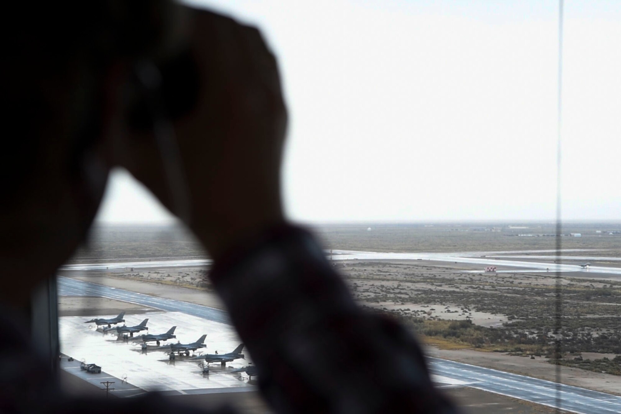 Daniel Howell, 54th Operations Support Squadron air traffic controller, observes an F-16 Fighting Falcon take off, Dec. 18, on Holloman Air Force Base, N.M. Air traffic controllers are responsible for every aircraft and vehicle on the airfield, as well as every aircraft in flight within a 10 to 15 mile radius (U.S. Air Force photo by Staff Sgt. BreeAnn Sachs)