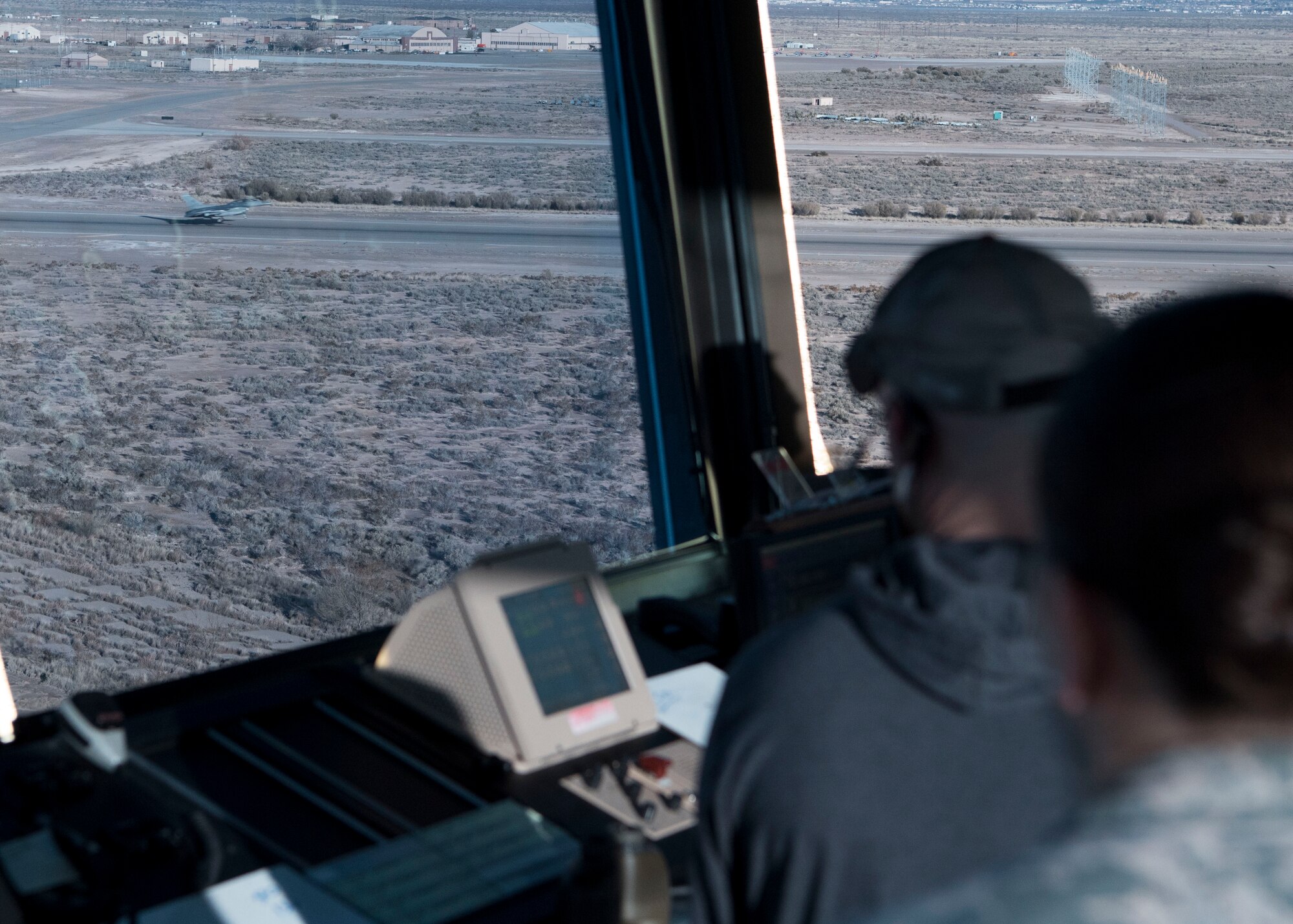 54th Operations Support Squadron air traffic controllers observe an F-16 Fighting Falcon take off, Dec. 18, on Holloman Air Force Base, N.M. Before an F-16 can take off or land they must be in contact with the air traffic control tower to ensure the runway is clear. (U.S. Air Force photo by Staff Sgt. BreeAnn Sachs)
