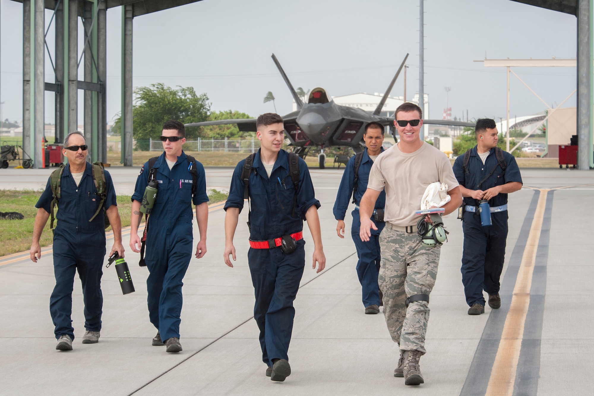 Active duty and Hawaii Air National Guard crew chiefs depart the Joint Base Pearl Harbor-Hickam flightline after prepping F-22 Raptors for flight Dec. 10, 2018