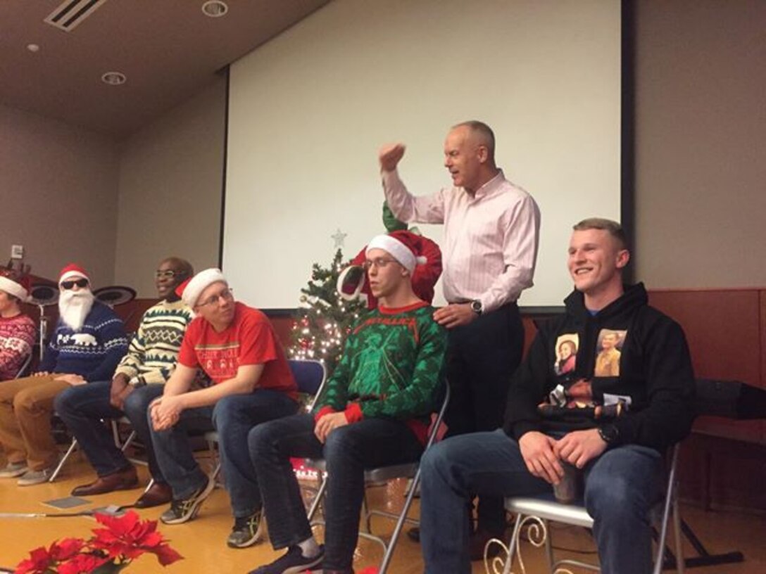 CAMP HUMPHREYS, Republic of Korea – Maj. Gen. Patrick J. Hermesmann, commander of U.S. Marine Corps Forces Korea, judges the “Ugly Sweater” Competition during the MARFORK Holiday Party here, Dec. 21.  Marines and families used the Pacific Victors Chapel for the holiday party to celebrate the command’s accomplishments, strengthen relationships within the command, and share their common fellowship with each other.