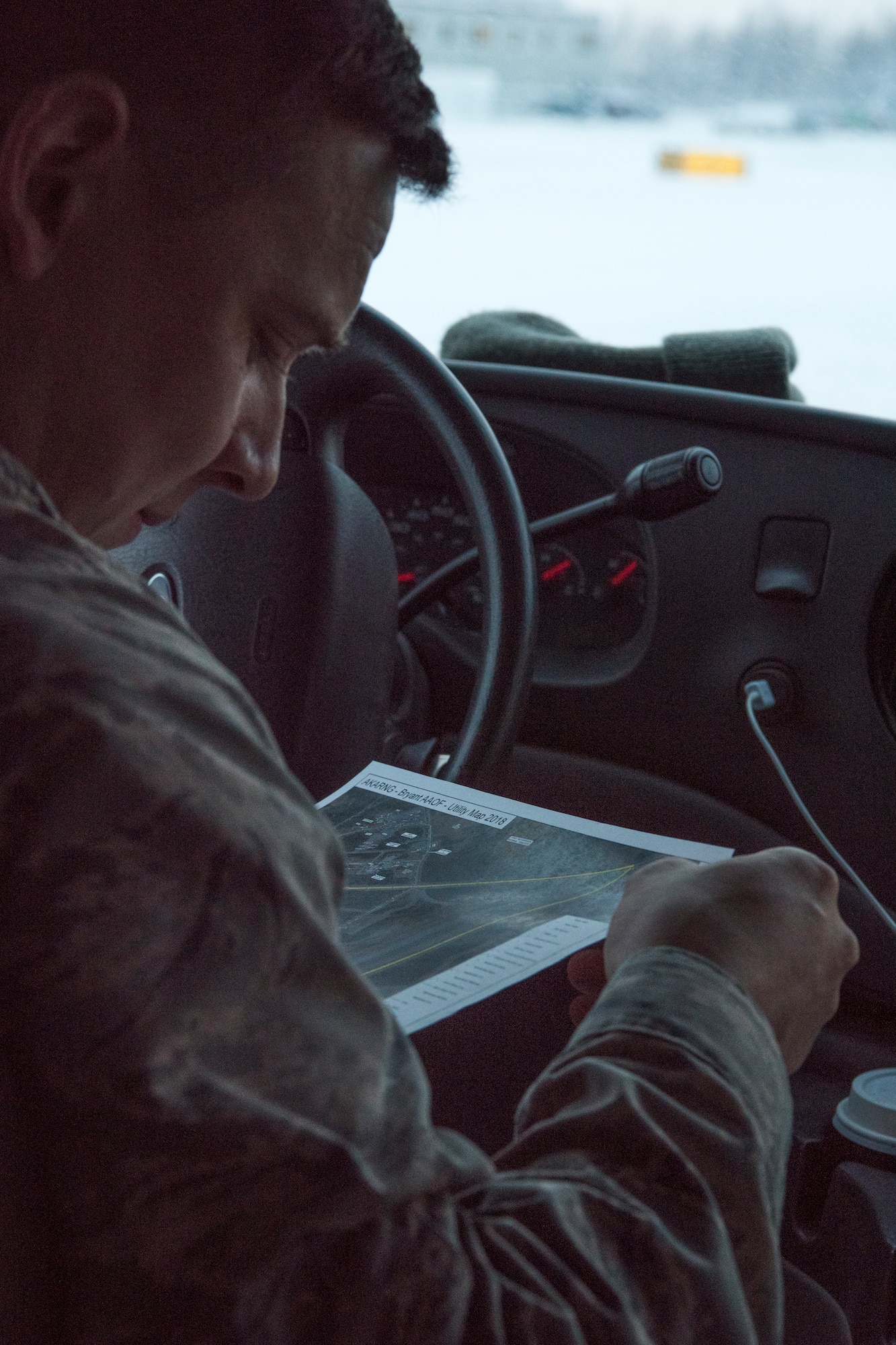 U.S. Air Force Capt. Benjamin Johnson, Air Force Civil Engineer Center’s Airfield Pavement Evaluation Team branch chief, looks at a map during an evaluation of Bryant Army Airfield at Joint Base Elmendorf-Richardson, Alaska Dec. 17, 2018. A two-person team used non-destructive testing to assess potential non-visible pavement damage at all of JBER’s airfields following the Nov. 30, 7.0 magnitude earthquake, whose epicenter was located just north of the base. (U.S. Air Force photo by Airman 1st Class Crystal A. Jenkins)