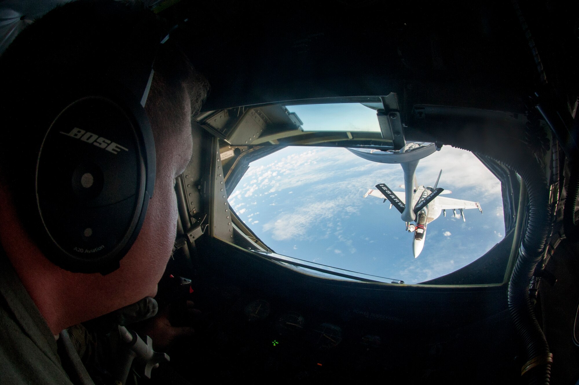 Master Sgt. Anthony Walter, 128th Air Refueling Squadron boom operator, conducts air refueling operations with an U.S. Navy F/A-18 Hornet Dec. 12, 2018