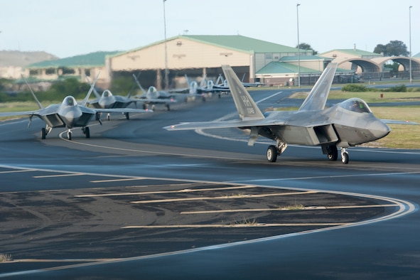 Hawaii Air National Guard F-22 Raptors from the 199th and 19th Fighter Squadrons taxi down the Joint Base Pearl Harbor-Hickam flight line Dec. 11, 2018