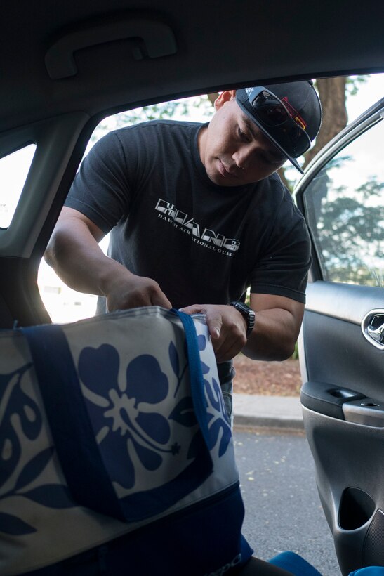 Staff Sgt. John Quijano, from the Hawaii Air National Guard’s 154th Logistics Squadron, prepares to deliver a meal to a disabled resident Dec. 17, 2018