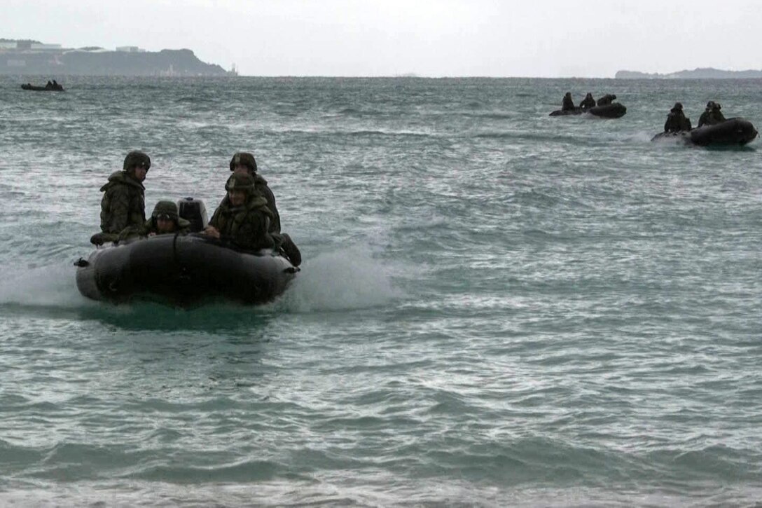 Marines with Alpha Company, Battalion Landing Team, 1st Battalion, 4th Marines, ride toward the shore aboard Combat Rubber Raiding Craft during a small boat raid as part of the 31st Marine Expeditionary Unit’s MEU Exercise, Kin Blue Beach, Okinawa, Japan, Dec. 12, 2018.