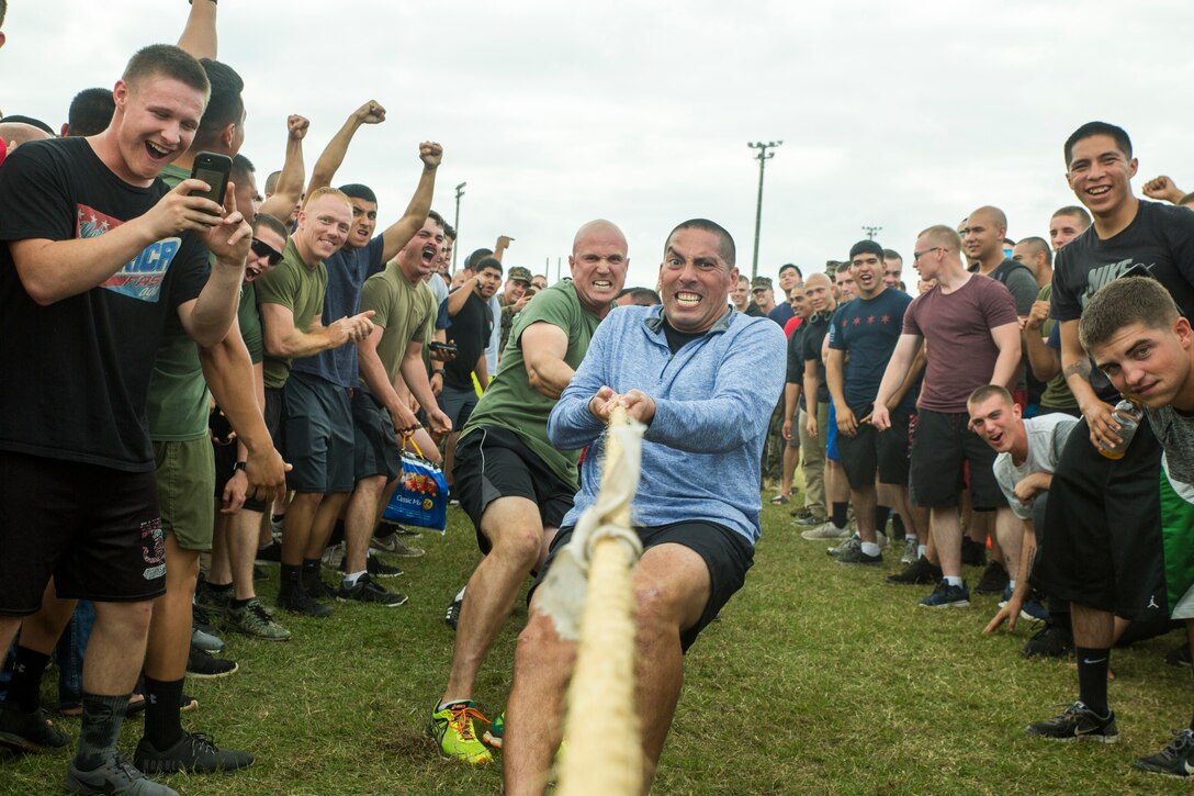 The staff noncommissioned officers of Battalion Landing Team, 1st Battalion, 4th Marines, compete against junior Marines in a tug of war during the unit wide field meet at Camp Hansen, Okinawa, Japan, Dec. 21, 2018. BLT 1/4, from Marine Corps Base Camp Pendleton, California, is the Ground Combat Element for the 31st Marine Expeditionary Unit. The 31st MEU, the Marine Corps only continually forward-deployed MEU, provides a flexible force ready to perform a wide range of military operations . (Official Marine Corps photo by Lance Cpl. Tanner D. Lambert/ Released)