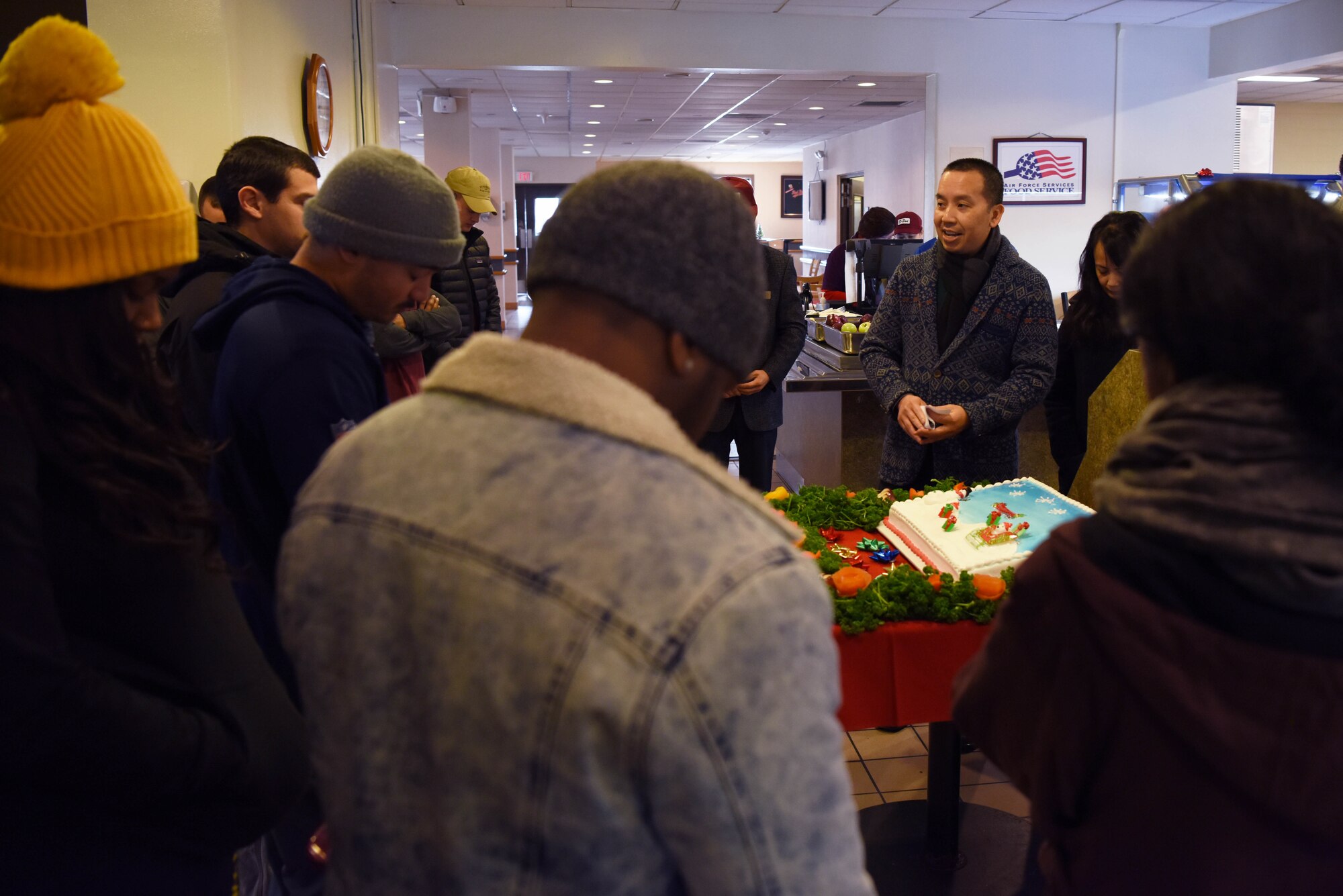 U.S. Air Force Capt. Joseph Hoang, 8th Fighter Wing chaplain, kicks off lunch with a prayer at Kunsan Air Base, Republic of Korea, Dec. 25, 2018. Leaders from the 8th Fighter Wing served meals to Airmen who spent the holiday away from home. (U.S. Air Force photo by Staff Sgt. Joshua Edwards)