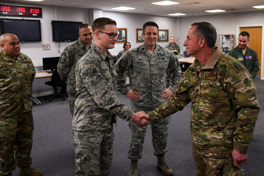 U.S. Air Force Airman 1st Class Christopher Allen, Air Combat Command 488th Intelligence Squadron client system technician, receives a coin from Air Force Chief of Staff Gen. David L. Goldfein at RAF Mildenhall, England, Dec. 26, 2018. Allen was coined for saving two Airmen’s lives and being a top performer in his unit. (U.S. Air Force photo by Tech. Sgt. Emerson Nuñez)