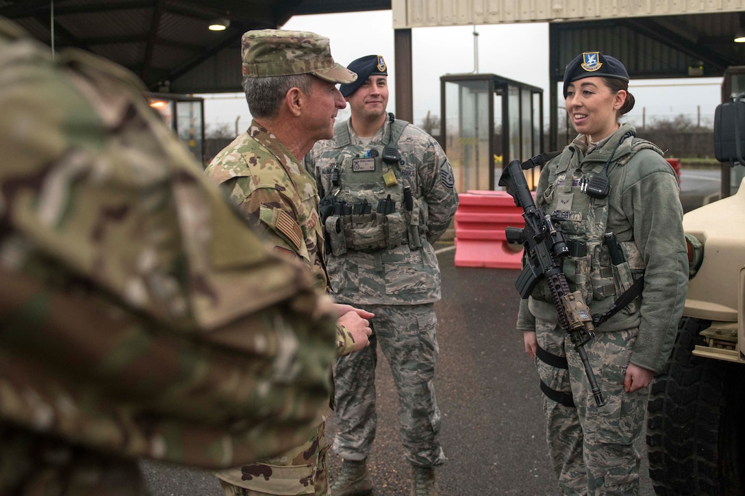 U.S. Air Force Airman 1st Class Meagan Crosby, 100th Security Forces Squadron response force member, speaks with Air Force Chief of Staff Gen. David Goldfein prior to being coined at RAF Mildenhall, England, Dec. 26, 2018. Crosby was recognized for being a top performer in the unit.  (U.S. Air Force photo by Staff Sgt. Christine Groening)