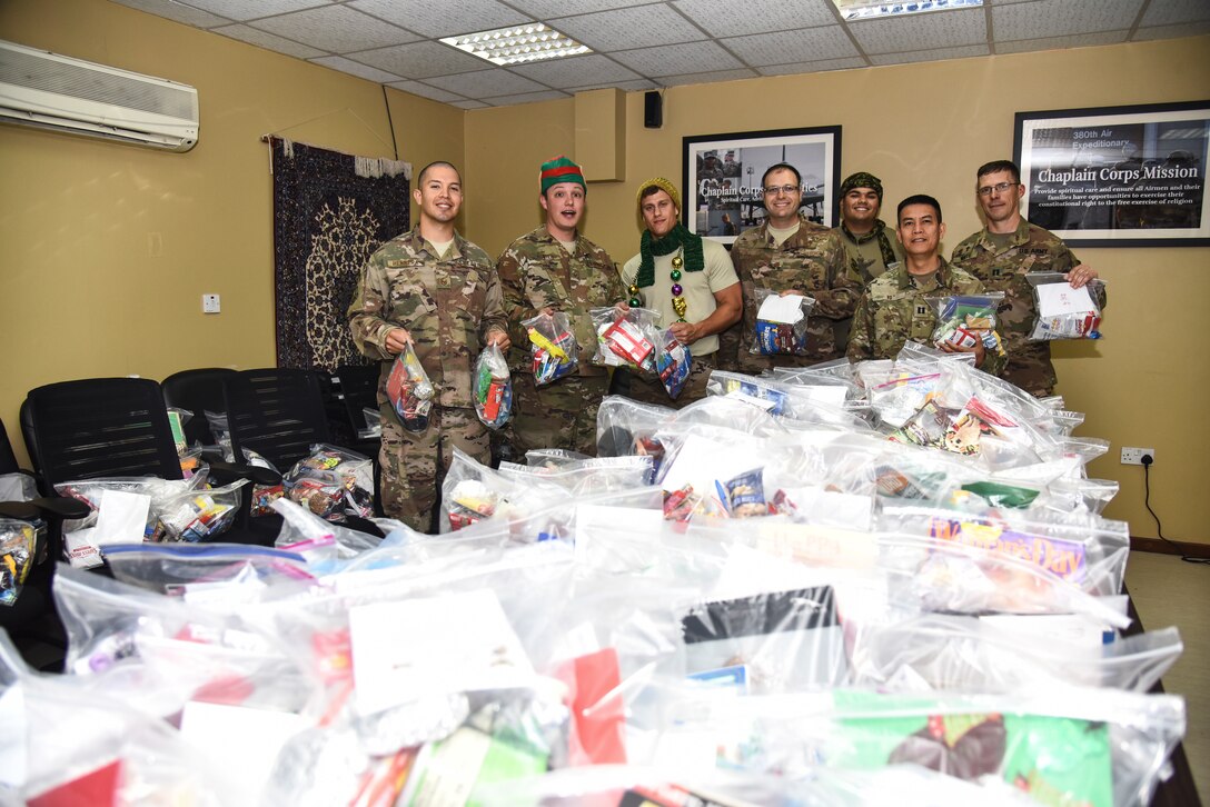 The U.S. Armed Forces Chapel Team poses for a photo with over 350 care packages at Al Dhafra Air Base, United Arab Emirates, Nov. 27, 2018. The team received the packages and distributed them through the base to all of the Airmen. The eight-member team is in charge of consulting with leadership on moral, ethical and quality-of-life issues; boosting the morale at ADAB by hosting and conducting regional trips and organizing events; providing resources for and conduct for worship services; and personally guiding any individual that knocks on their door. (U.S. Air Force photo by Senior Airman Mya M. Crosby)
