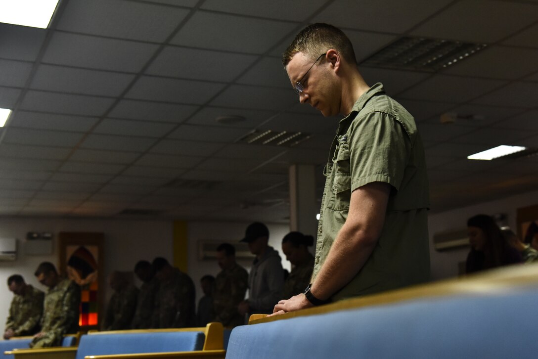 A U.S. service member bows his head in silence during a religious service at Al Dhafra Air Base, United Arab Emirates, Dec. 25, 2018. The eight-member team is in charge of consulting with leadership on moral, ethical and quality-of-life issues; boosting the morale at ADAB by hosting and conducting regional trips and organizing events; providing resources for and conduct for worship services; and personally guiding any individual that knocks on their door. (U.S. Air Force photo by Senior Airman Mya M. Crosby)