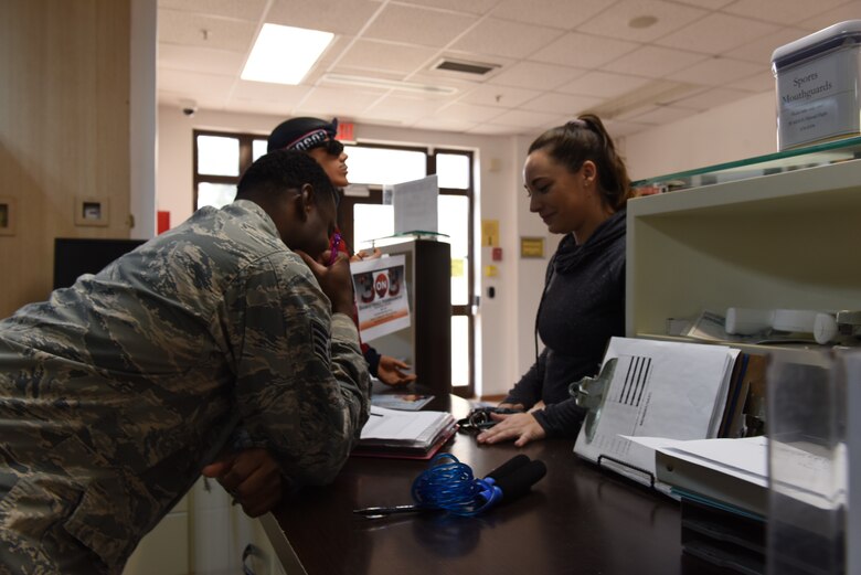 U.S. Air Force Staff Sgt. Ronnie Drake, 39th Force Support Squadron fitness center supervisor, signs a service member up for a fitness center access card at Incirlik Air Base, Turkey, Nov. 21, 2018.