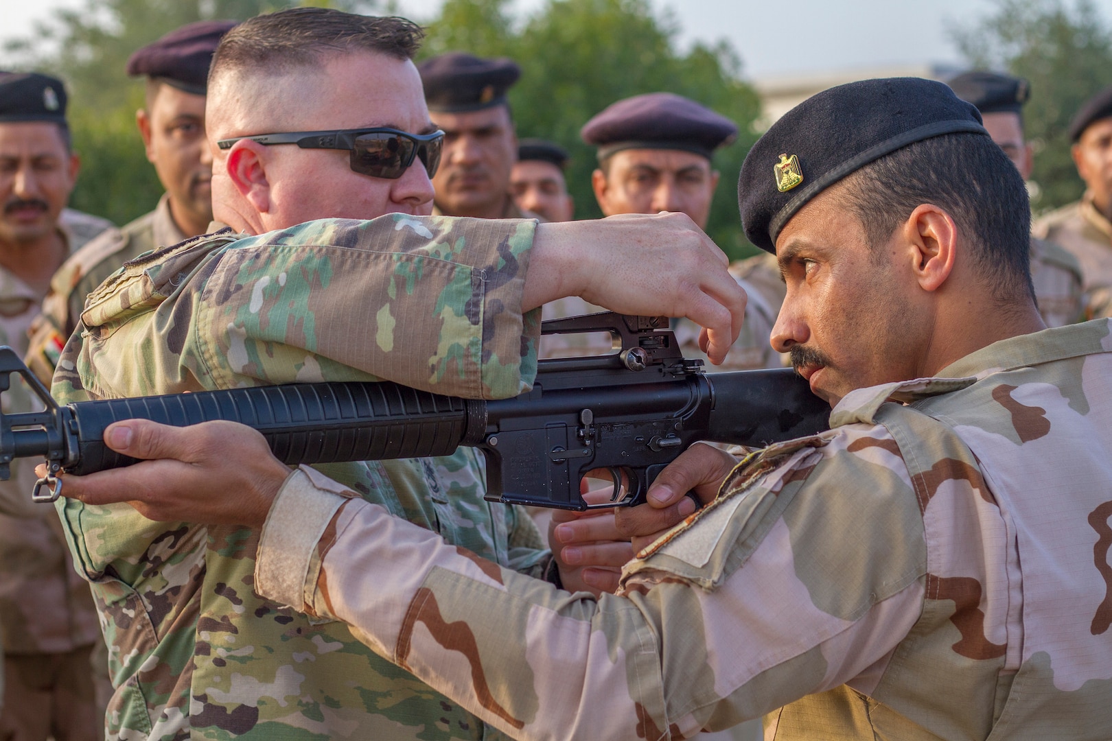 U.S. Army Sgt. 1st Class Michael Garner, left, security forces platoon sergeant assigned to Task Force India Bravo, teaches an Iraqi army primary marksmanship instruction course at Camp Taji, Iraq, Dec.19, 2018.
