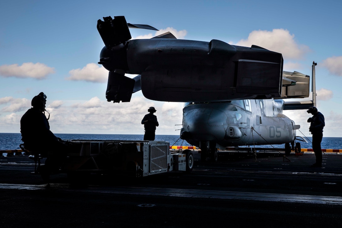 Sailors transport an MV-22 Osprey with the 22nd Marine Expeditionary Unit to the hangar bay via elevator aboard the USS Kearsarge, Dec. 27, 2018. The 22nd MEU is currently on deployment to the 5th and 6th fleet areas of responsibility with the Kearsarge Amphibious Ready Group.