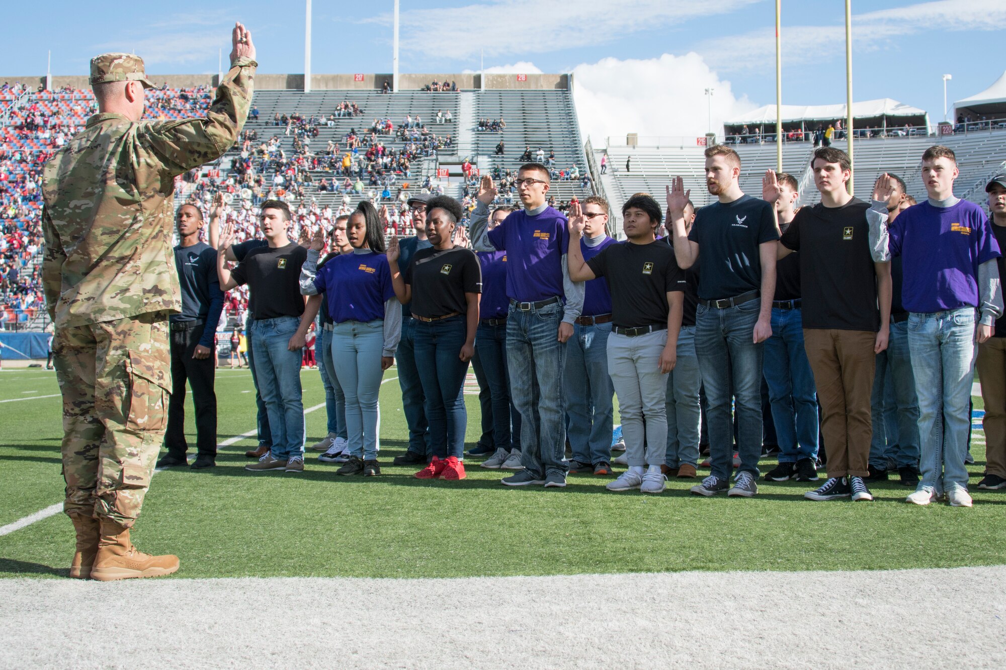 U.S. Air Force Col. Michael Miller, 2nd Bomb Wing commander, administers the oath of enlistment to local recruits during the 2018 Walk On’s Independence Bowl in Shreveport, Louisiana, December 27th, 2018. The recruits that took the oath were slated to join various branches and components of the military. (U.S. Air Force photo by Airman 1st Class Maxwell Daigle)