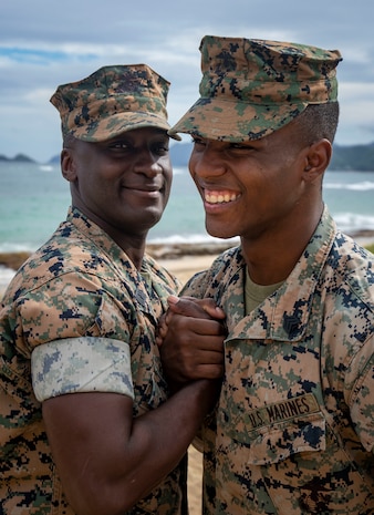 Master Sgt. Ezekiel Kitandwe, the staff noncommissioned officer in charge of Marine Corps Base Hawaii (MCBH) Communication Strategy and Operations, congratulates Sgt. Zachary Orr following his re-enlistment ceremony, MCBH, Nov. 15, 2018. (U.S. Marine Corps photo by Cpl. Luke Kuennen)