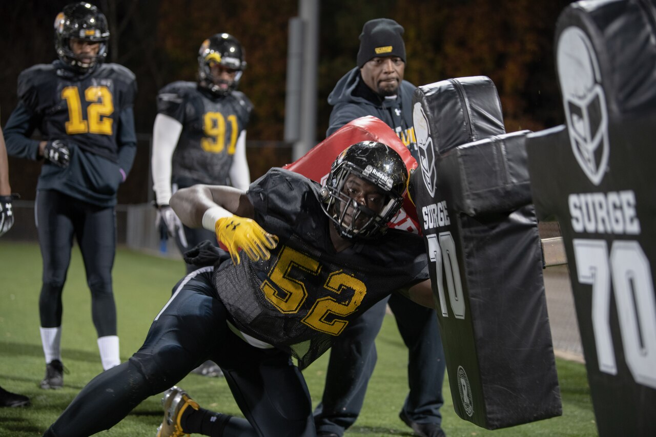 A football player charges a football sled