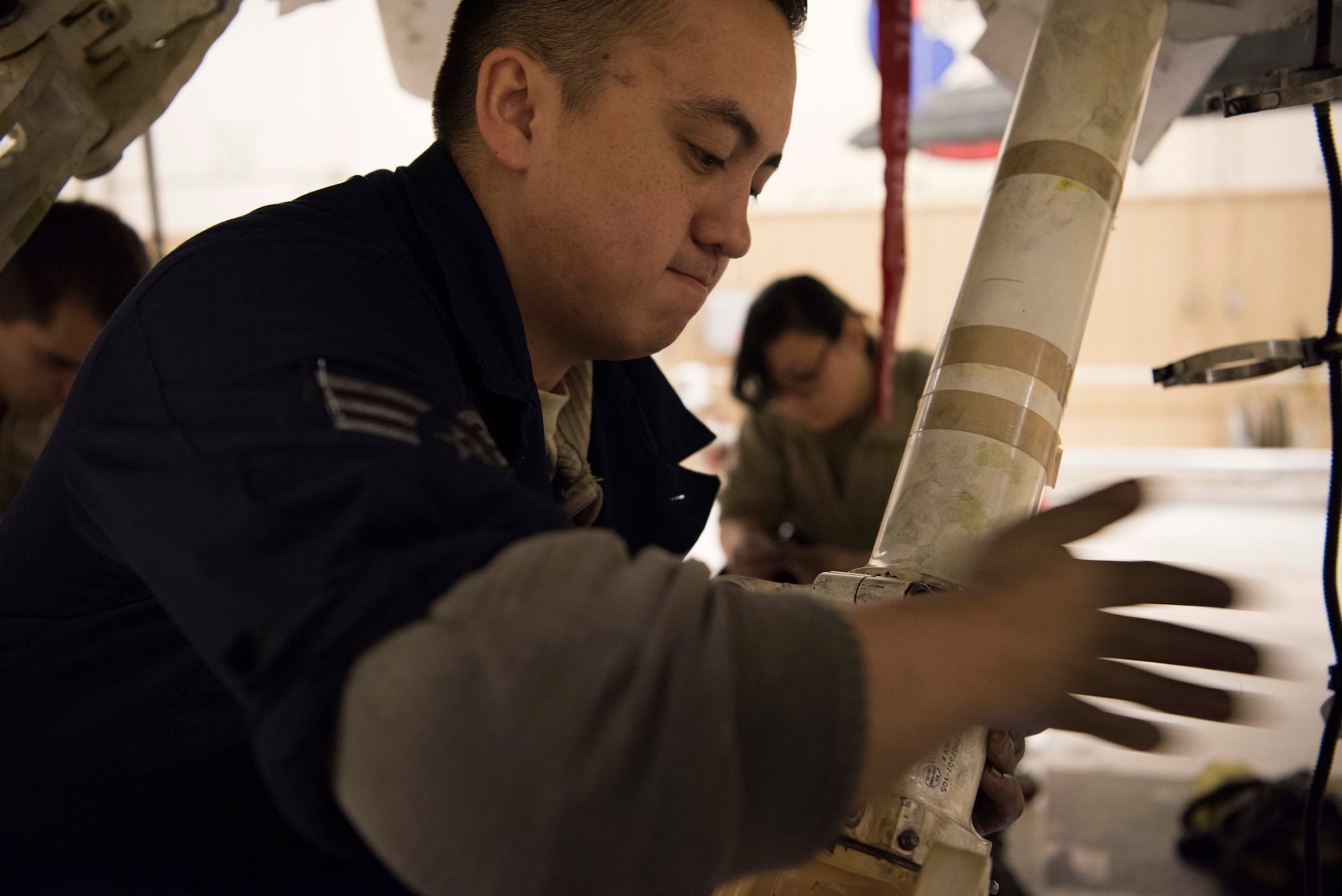 Senior Airman Jordan Eveland, 314th Aircraft Maintenance Unit dedicated crew chief, performs maintenance on an F-16 Fighting Falcon Oct. 18 on Holloman Air Force Base, N.M. As a DCC Eveland is assigned to a specific aircraft, and is responsible for all fight essential maintenance on his aircraft. (U.S. Air Force photo by Staff Sgt. BreeAnn Sachs)