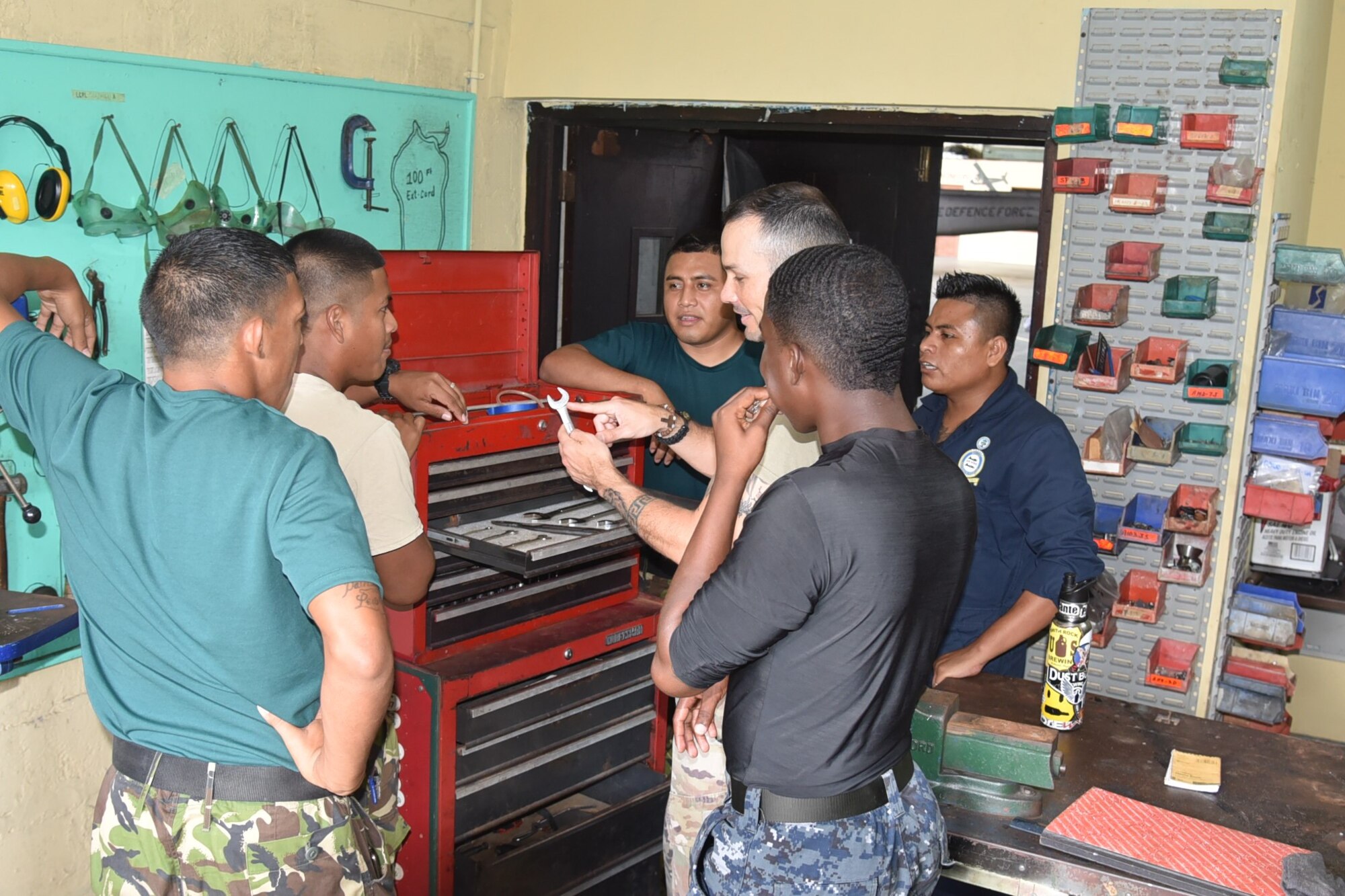 Master Sgt. Raphael Romero, 571st Mobility Support Advisory Squadron aircraft maintenance air advisor, trains members from the Belize Defense Force Air Wing on tool control techniques during a mobile training mission in Ladyville, Belize. (Courtesy Photo)