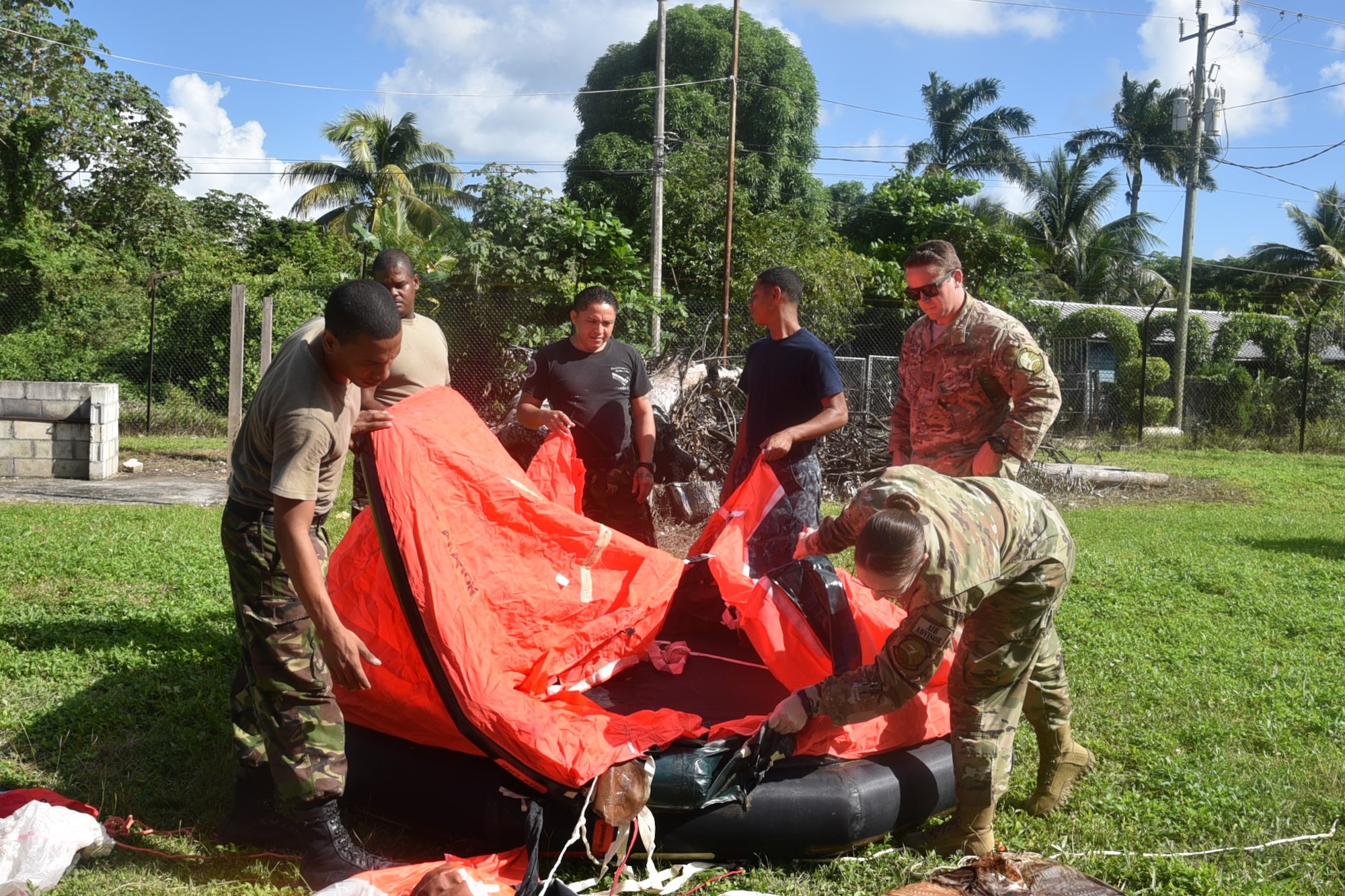 Master Sgt. Natasha Titemore, 571st Mobility Support Advisory Squadron aircrew flight equipment air advisor, trains members from the Belize Defense Force Air Wing on water survival equipment during a mobile training mission in Ladyville, Belize. (Courtesy Photo)