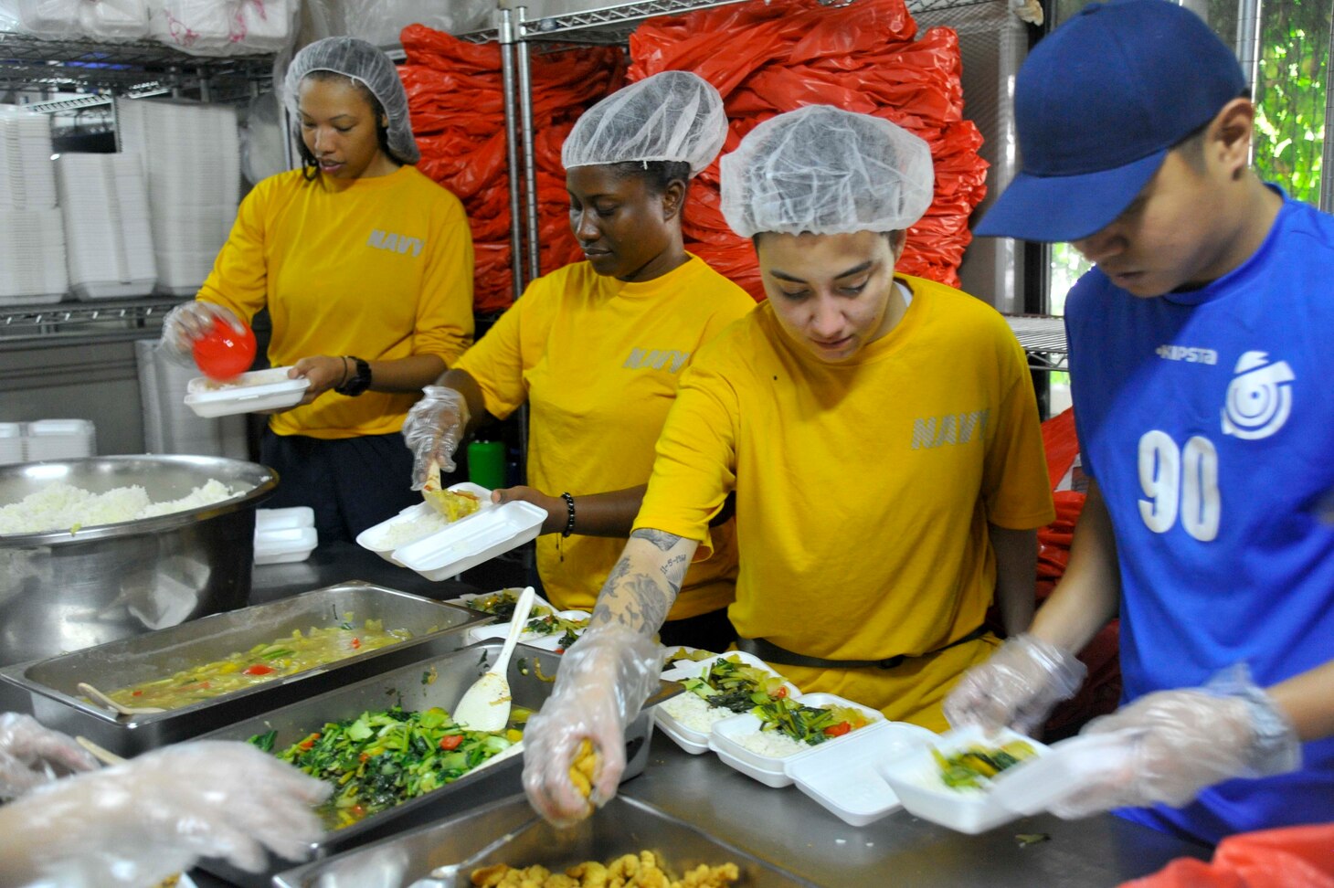 SINGAPORE (Dec. 20, 2018) – Sailors assigned to the submarine tender USS Emory S. Land (AS 39) build meal boxes during a community service event at the Willing Hearts Soup Kitchen in Singapore, Dec. 20. Emory S. Land is a forward-deployed expeditionary submarine tender on an extended deployment conducting coordinated tended moorings and afloat maintenance in the U.S. 5th and 7th Fleet areas of operations.