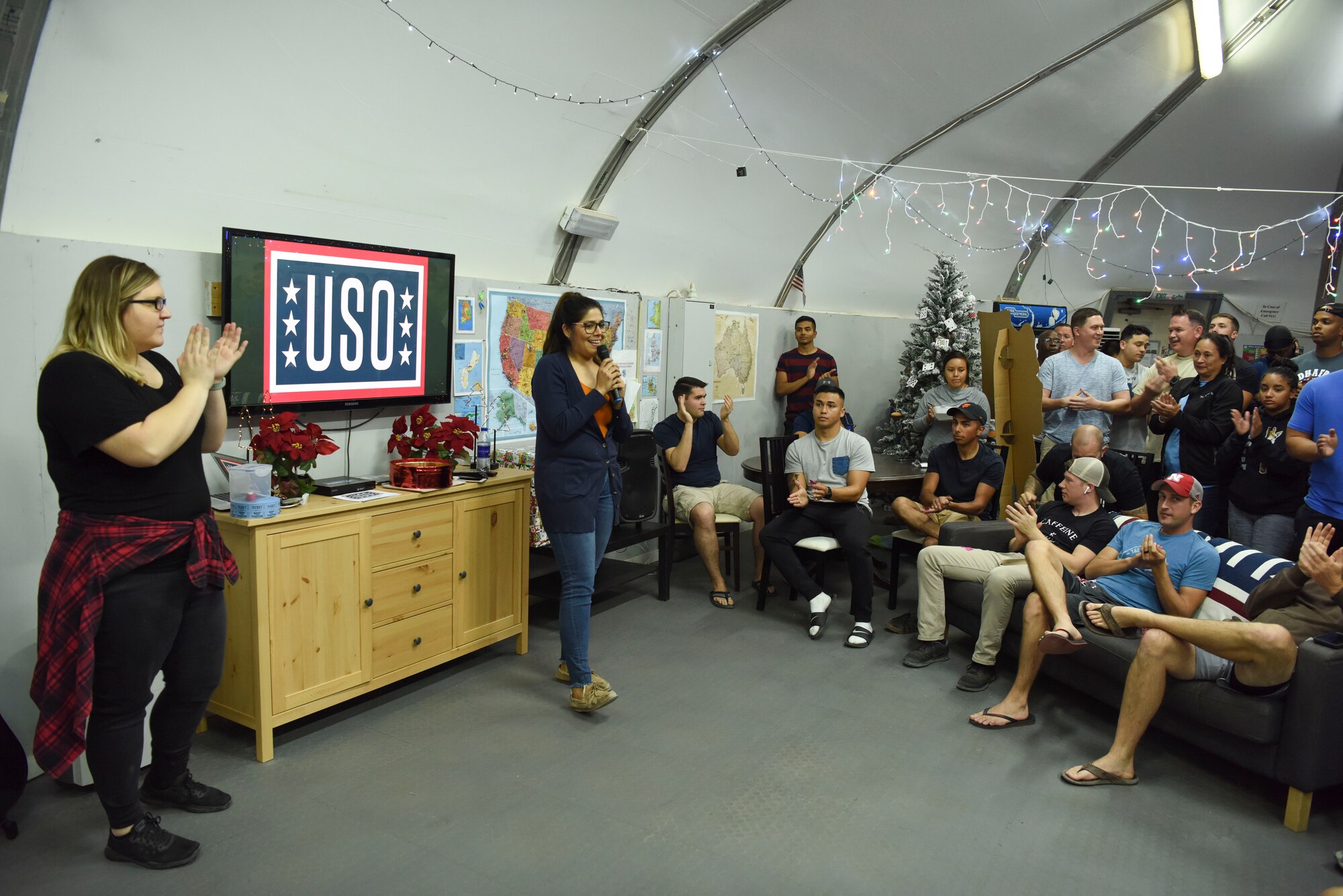 Lucie Sertich, USO outreach coordinator (left), and Marisela Rodriguez, USO center manager (middle), host a raffle contest at Al Dhafra Air Base, United Arab Emirates, Dec. 18, 2018.