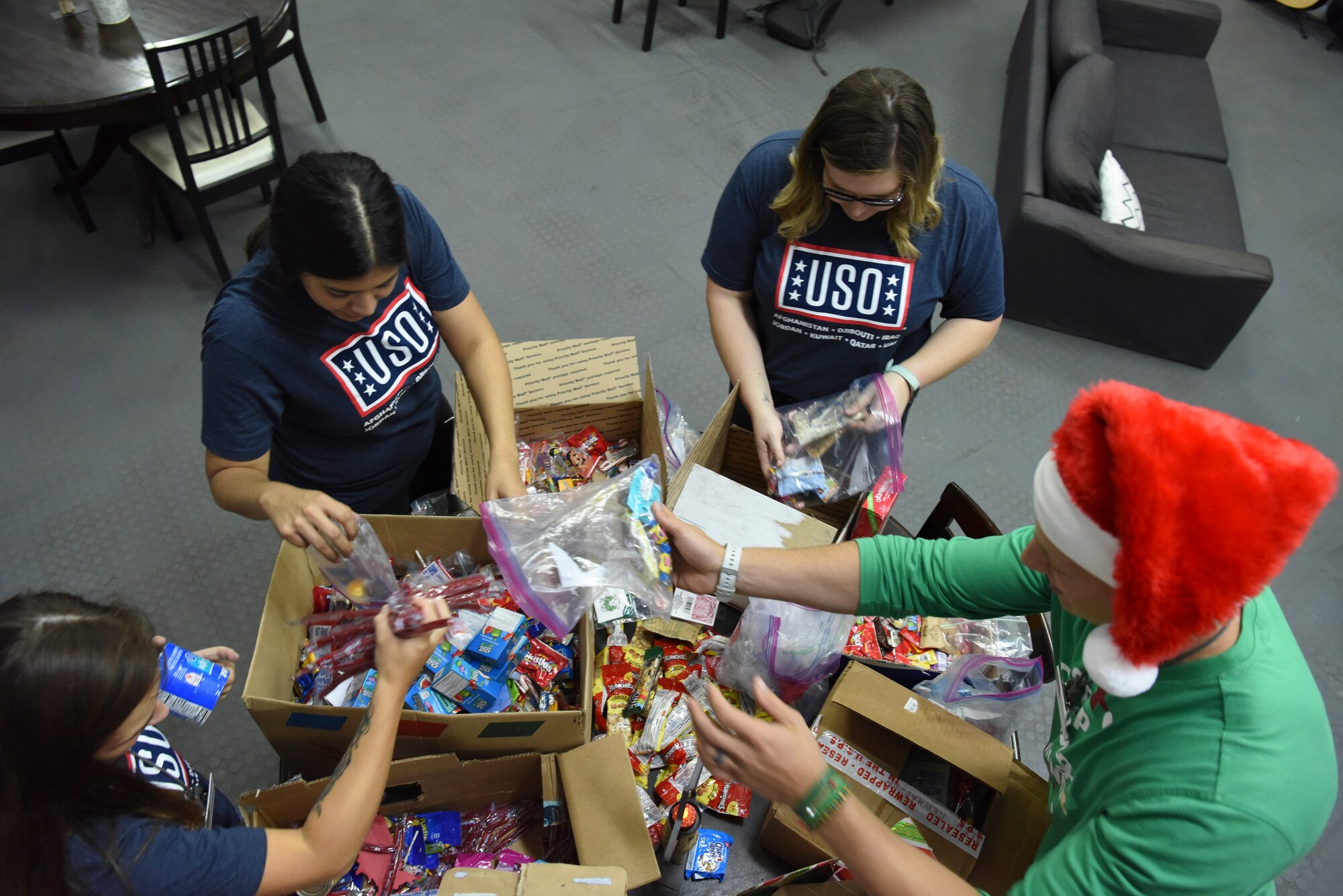 USO Staff and volunteers sort through donated boxes at Al Dhafra Air Base, United Arab Emirates, Dec. 20, 2018.