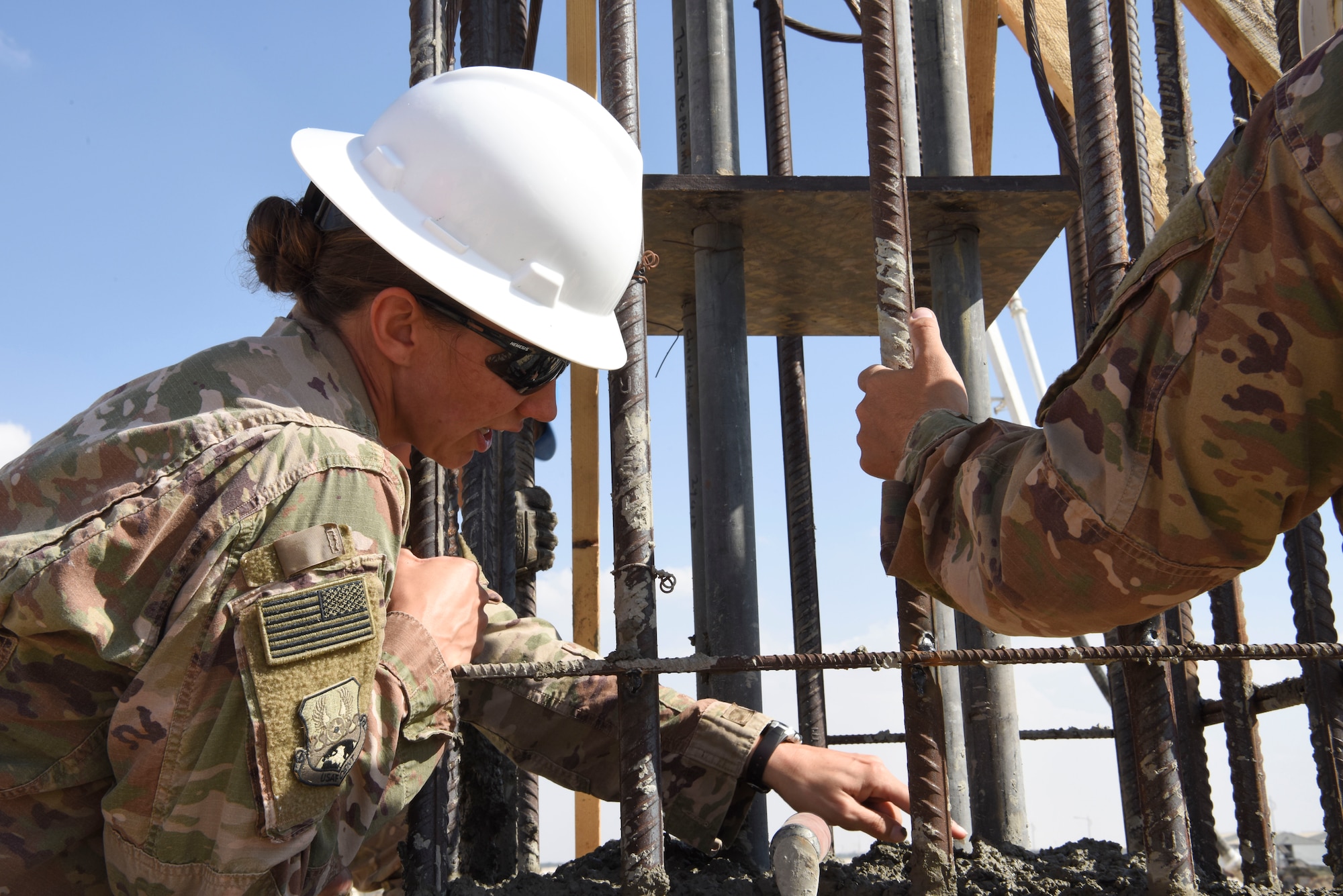 Capt. Paige Blackburn, 577 EPBS officer in charge of troop construction, inspects the concrete poured into the foundation system to support a build during construction, Dec. 23, 2018 at Al Dhafra Air Base, United Arab Emirates.