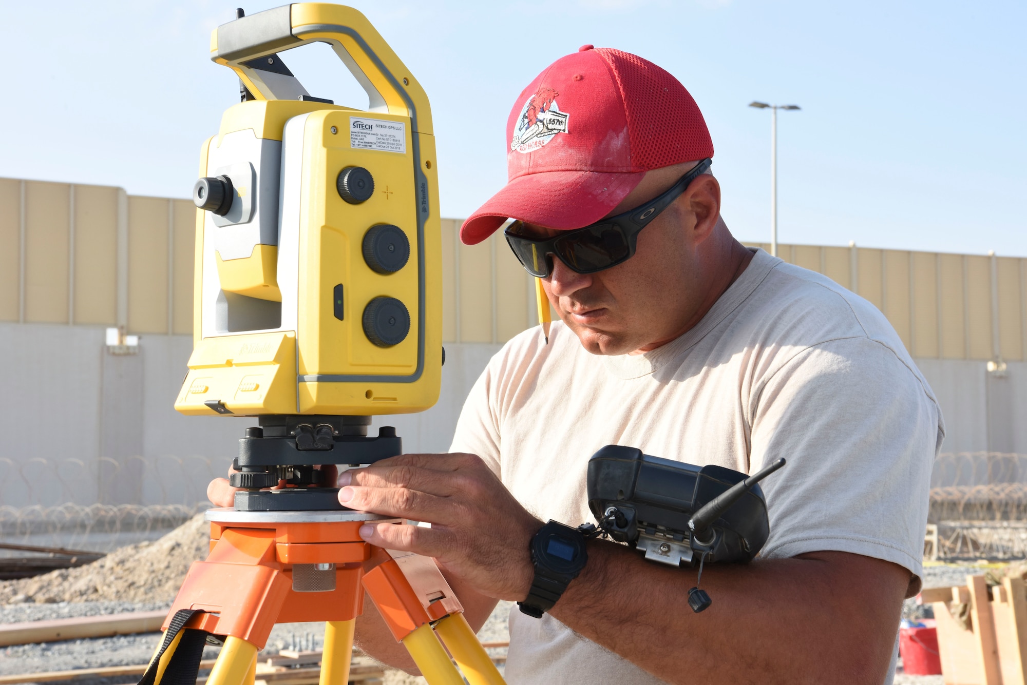 Staff Sgt. Thomas Findlay, 557th Expeditionary Rapid Engineer Deployable Heavy Operational Repair Squadron, engineering assistant, uses a Topcon Total Station for topographic survey of the land during construction of Air Field Damage repair equipment warehouse, Dec. 23, 2018 at Al Dhafra Air Base, United Arab Emirates.