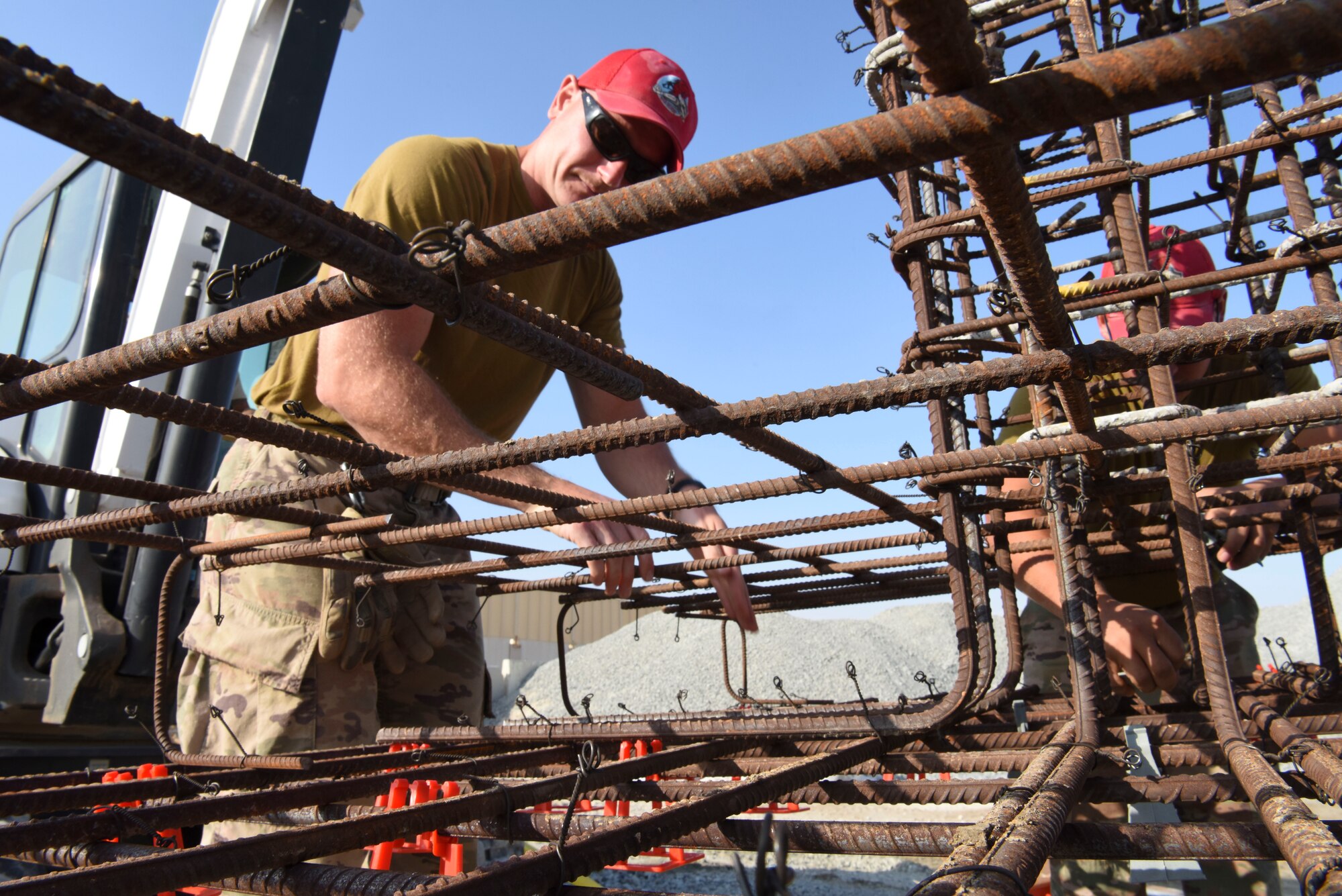 Tech. Sgt. Tracee Crane, 557th Expeditionary Rapid Engineer Deployable Heavy Operational Repair Squadron, Engineering pavement and equipment operator, places concrete chairs onto rebar during construction of Air Field Damage repair equipment warehouse, Dec. 23, 2018 at Al Dhafra Air Base, United Arab Emirates.