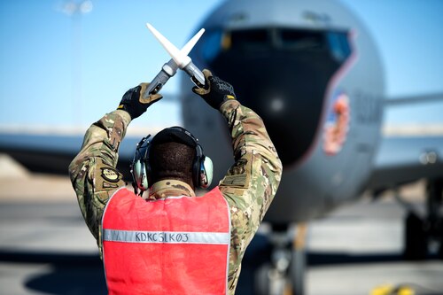 An Airman assigned to the 451st Expeditionary Aircraft Maintenance Squadron signals a KC-135 Stratotanker Aircraft at Kandahar Airfield, Afghanistan Dec. 21, 2018.
