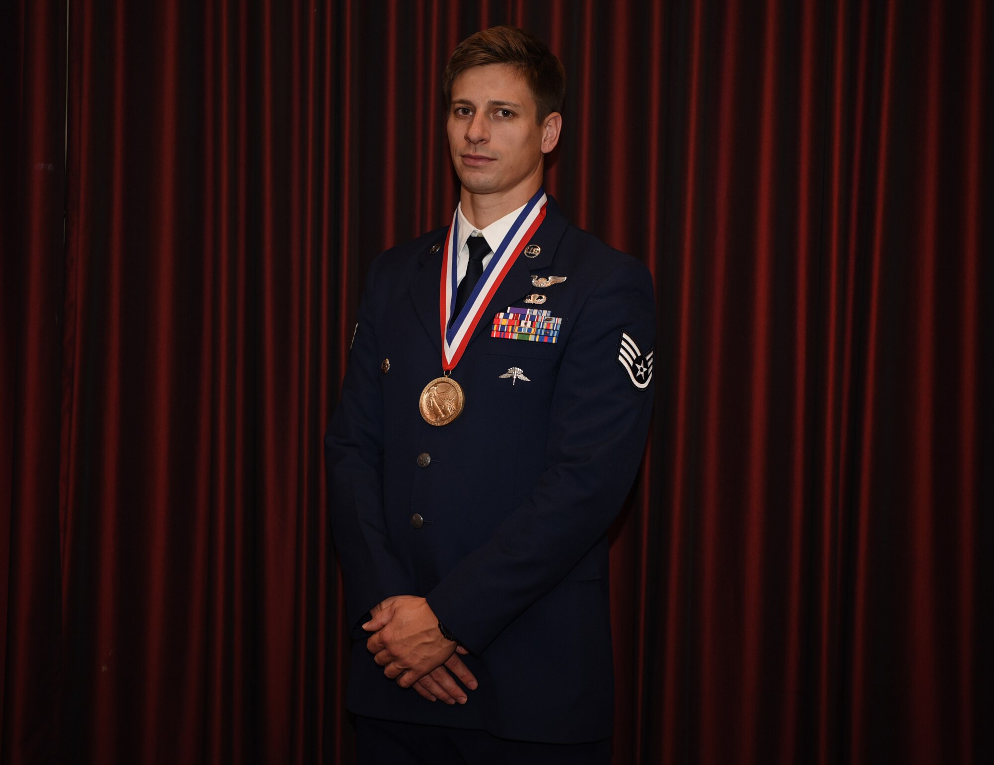 U.S. Air Force Staff Sgt. Aaron Metzger, 38th Rescue Squadron pararescueman stationed at Moody Air Force Base, Georgia, poses for a photo during the 57th Annual USO Armed Forces Gala at the New York Marriott Marquis in New York City, Dec. 12, 2018. Metzger received the George Van Cleave Military Leadership Award for rescuing and providing medical aid to injured allies, foreign and domestic, while critically injured as well. (U.S. Air Force photo by Airman 1st Class Ariel Owings)