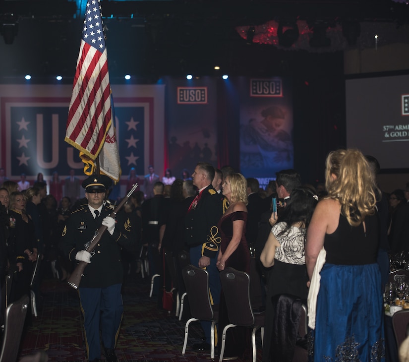 An honor guard, comprised of service members from all branches of the U.S. Armed Forces, walks in formation during the 57th Annual USO Armed Forces Gala at the New York Marriott Marquis in New York City, Dec. 12, 2018. The audience members of the gala stood in respect to honor and support military members and their families. (U.S. Air Force photo by Airman 1st Class Ariel Owings)