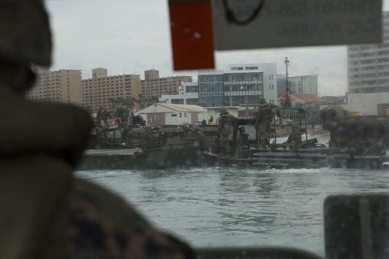Cpl. Austin Sprague, a combat engineer with Bridge Company, 9th Engineer Support Battalion, Combat Logistics Regiment 35, observes and provides feedback to Marines with Bridge Co. moving an Improved Ribbon Bridge (IRB) bay at Naha Military Port, Okinawa, Japan Jan. 31, 2018. Sprague, a native of Martinsville, Indiana, operated a Bridge Erection Boat for Marines setting up the IRBs. (U.S. Marine Corps photo by Pfc. Jamin M. Powell)