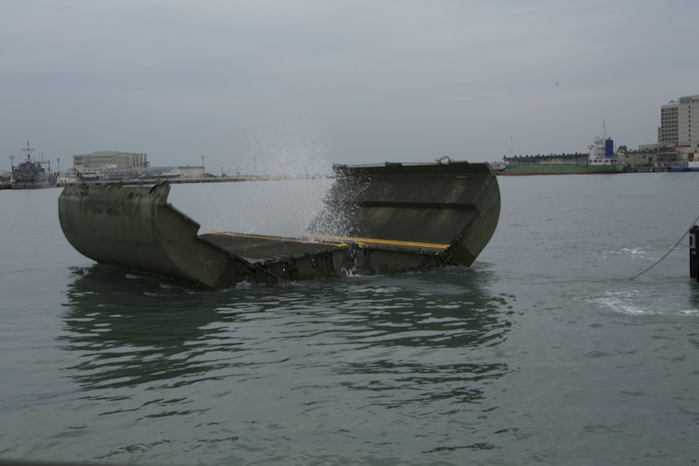 An Improved Ribbon Bridge (IRB) bay springs open after Marines with Bridge Co., 9th Engineer Support Battalion, Combat Logistics Regiment 35, pull the pin to deploy it at Naha Military Port, Okinawa, Japan Jan. 31, 2018. Bridge Co. conducted training with IRBs to train new Marines and to show the capabilities of the newly-formed company. (U.S. Marine Corps photo by Pfc. Jamin M. Powell)