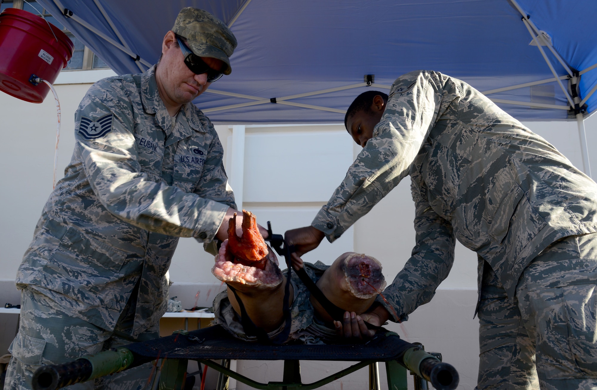 U.S. Air Force Airmen practice applying a tourniquet to a training manikin during Ability to Survive and Operate (ATSO) training at MacDill Air Force Base, Fla., Jan. 26, 2018.