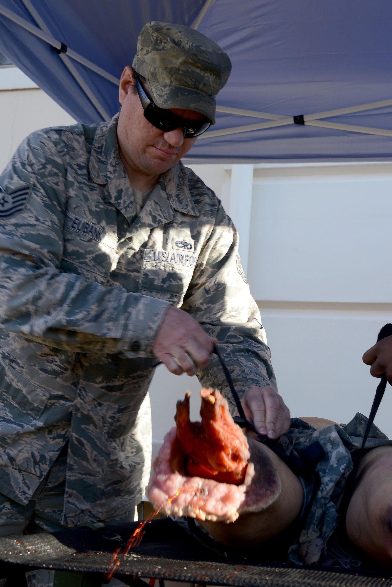 Tech. Sgt. Frank Eubank, maintenance operations center senior controller assigned to the 6th Maintenance Squadron, applies a tourniquet to a training manikin during Ability to Survive and Operate (ATSO) training at MacDill Air Force Base, Fla., Jan. 26, 2018.