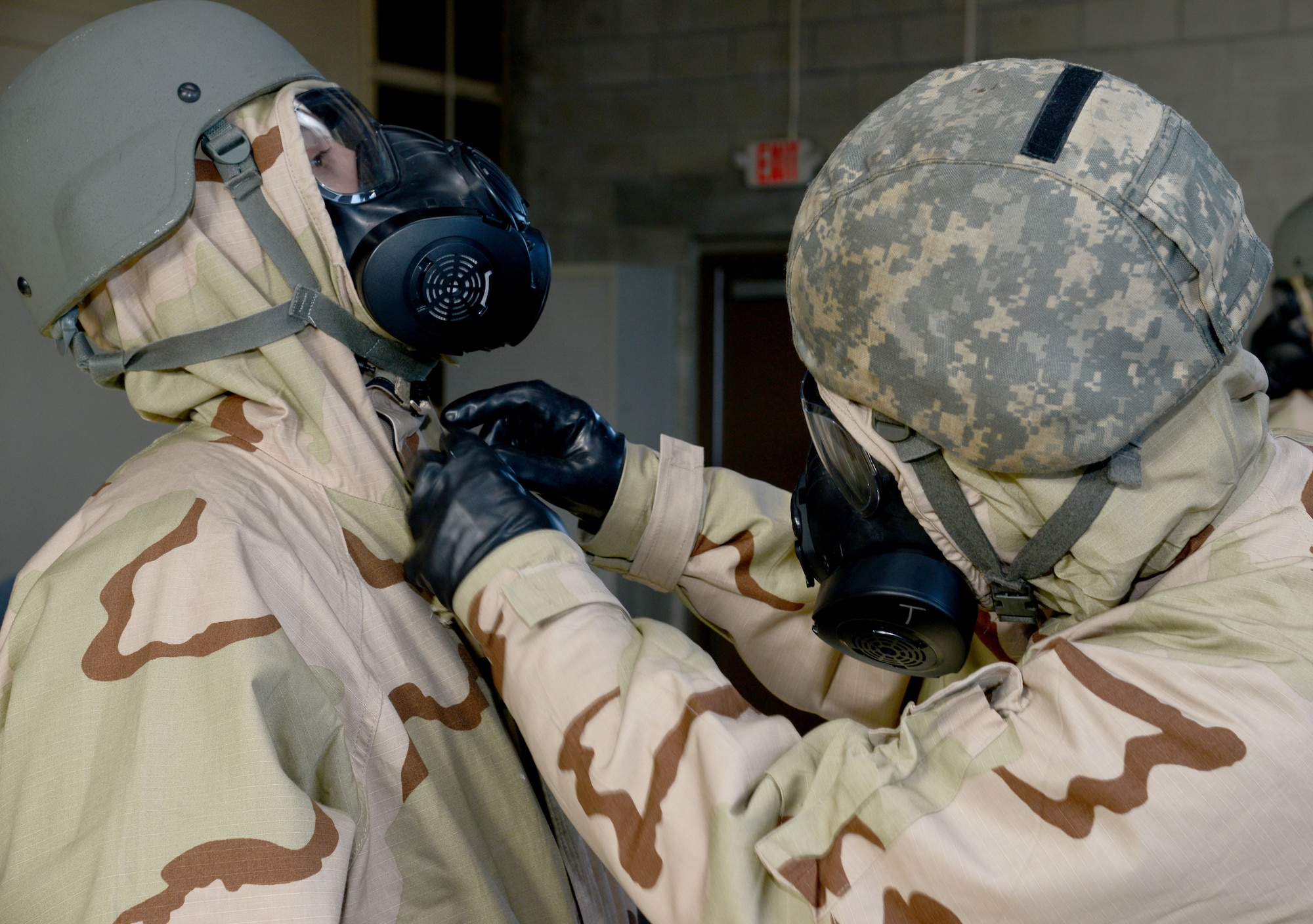 U.S. Air Force Airmen perform a “buddy check” to make sure mission oriented protective posture gear is being worn properly at MacDill Air Force Base, Fla., Jan. 26, 2018.