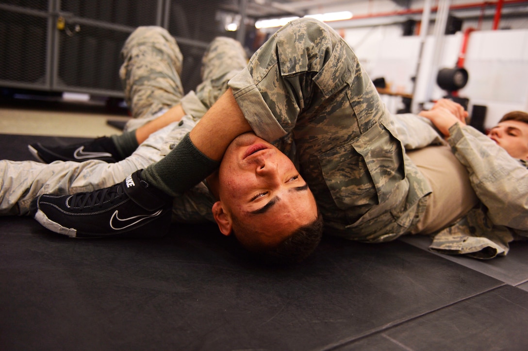 Security forces Airmen participate in a combatives class during a mobile Phoenix Raven Qualification Course on Ramstein Air Base, Germany, Jan. 30, 2018. Raven instructors assigned to the 421st Combat Training Squadron on Joint Base McGuire-Dix-Lakehurst, New Jersey, formed a mobile training team to conduct the course on Ramstein. (U.S. Air Force photo by Senior Airmen Joshua Magbanua)
