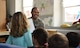 U.S. Air Force Airman 1st Class Milton Hamilton smiles as he reads a children's book to a class of German kindergarteners Jan. 30, 2018 at Villa Winzig in Kaiserslautern, Germany. This was part of an initiative to further support Ramstein Air Base relations with the Kaiserslautern community.