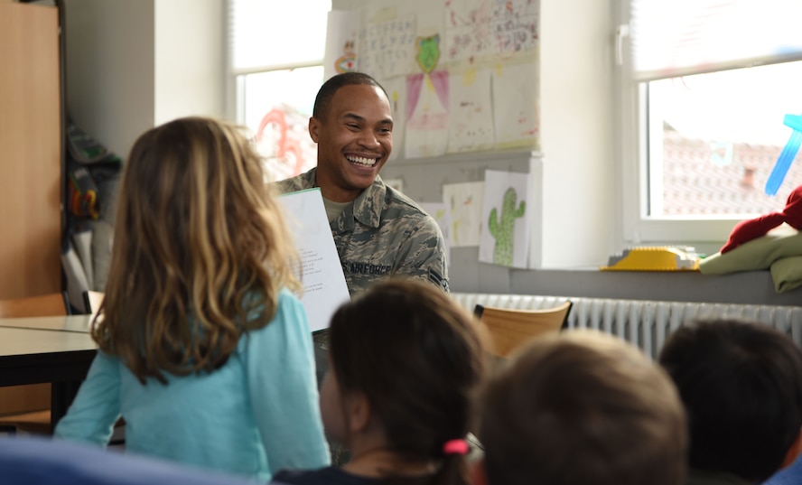 U.S. Air Force Airman 1st Class Milton Hamilton smiles as he reads a children's book to a class of German kindergarteners Jan. 30, 2018 at Villa Winzig in Kaiserslautern, Germany. This was part of an initiative to further support Ramstein Air Base relations with the Kaiserslautern community.