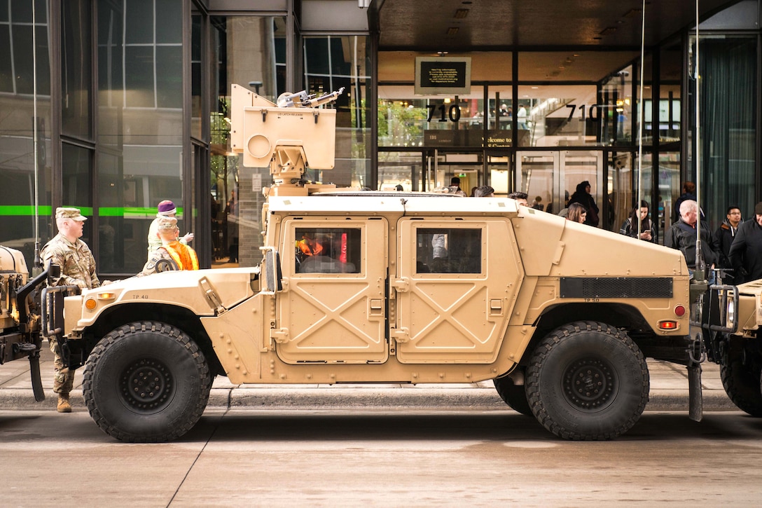 A Humvee is parked in front of a building.