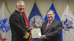 Defense Contract Management Agency Director Navy Vice Adm. David Lewis presents Timothy Callahan, DCMA executive director of Contracts, with a certificate during Callahan’s retirement ceremony at Fort Lee, Virginia, Jan. 31. (DCMA photo by Elizabeth Szoke)