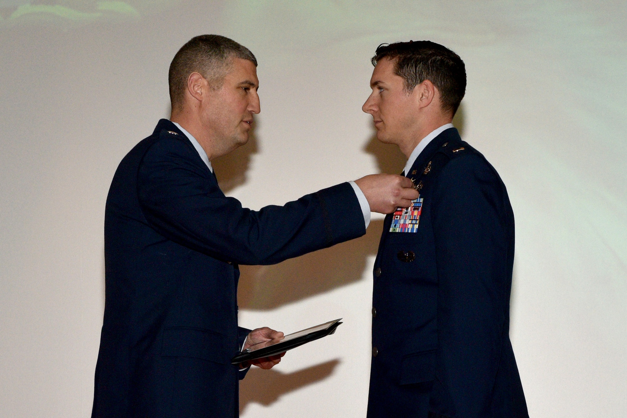 U.S. Air Force Lt. Col. Kenneth Stremmel, 315th Training Squadron commander, presents the Purple Heart medal to 2nd Lt. Daniel Hipps, 315th TRS trainee, during the 315th graduation ceremony in the Base Theater on Goodfellow Air Force Base, Texas, Jan. 31, 2018. The Purple Heart is awarded to members of the U.S. armed forces who were wounded by an instrument of war in the hands of an enemy and posthumously to the next of kin in the name of those who are killed in action or die of wounds received in action. (U.S. Air Force photo by Senior Airman Randall Moose/Released)