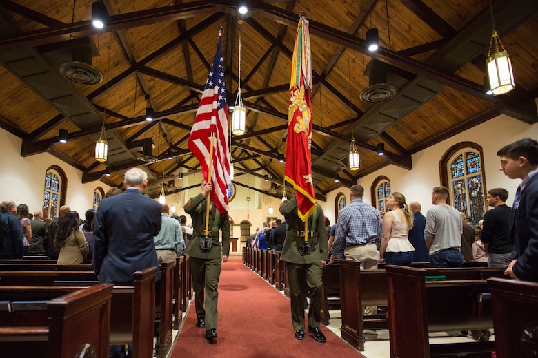 The color guard posts the national and Marine Corps colors during mass for the 75th anniversary of the St. Francis Xavier Catholic Chapel, Jan. 28, on Marine Corps Base Camp Lejeune.