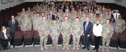 Soldiers and civilians pose for a photo before Maj. Gen. Stuart W. Risch, the deputy Judge Advocate General for the U.S. Army, delivers his State of Corps address Jan. 9 at the Donald Evans Auditorium at Joint Base San Antonio-Fort Sam Houston. The purpose of address was to inform the attendees about what to expect during the Article 6 visit.