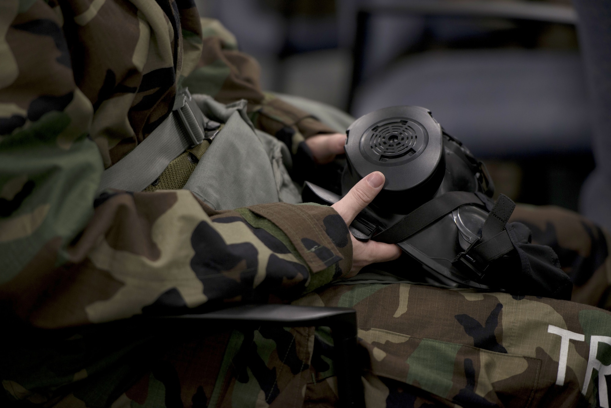 A U.S. Air Force Airman assigned to the 6th Air Mobility Wing prepares to don a gas mask during Ability to Survive and Operate training (ATSO) at MacDill Air Force Base, Fla., Jan. 27, 2018.