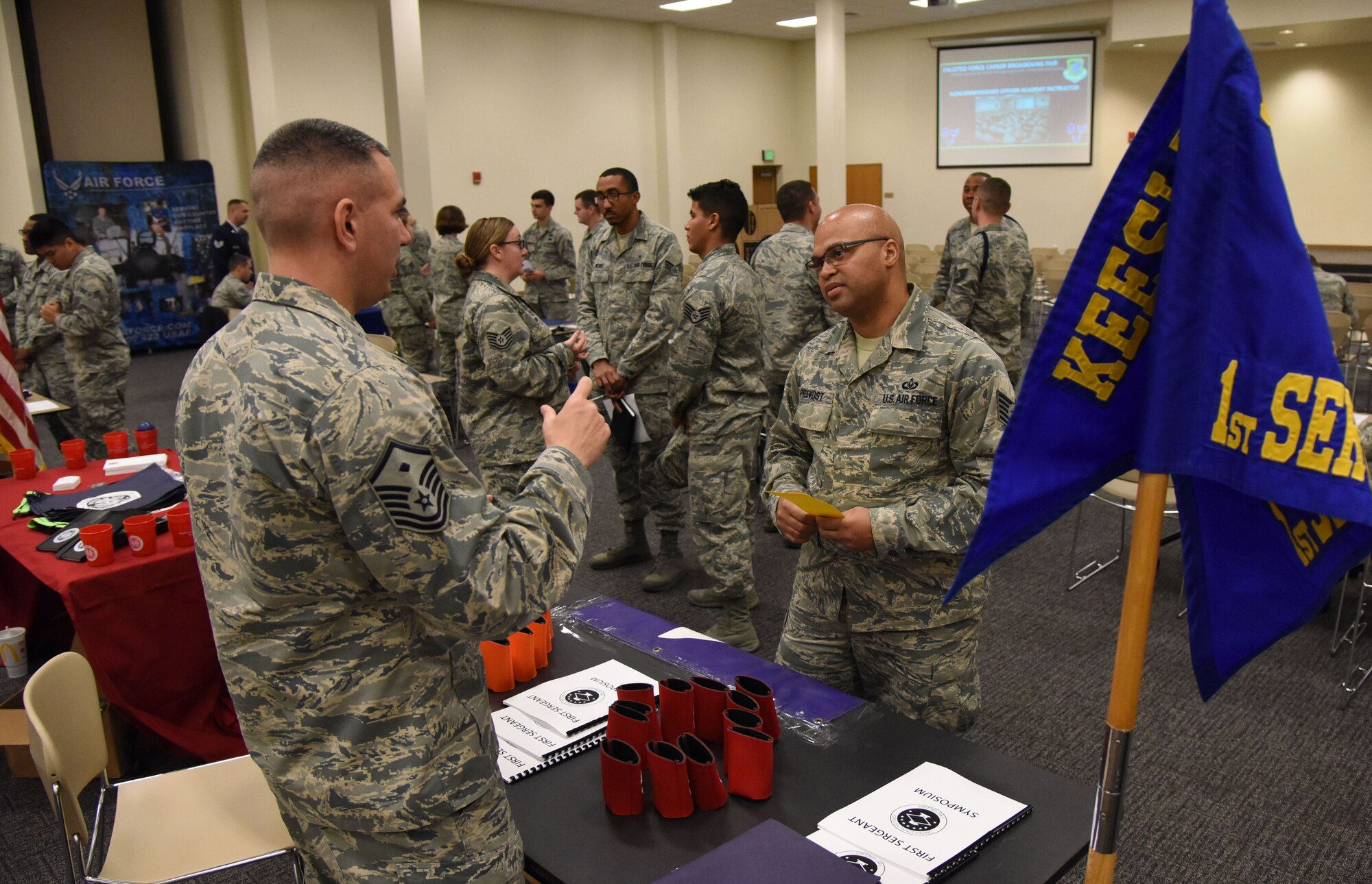 Master Sgt. Jason Meuse, 338th Training Squadron first sergeant, briefs Tech. Sgt. Marlon Prevost, 403rd Operations Support Squadron aircrew flight equipment technician, on duties as a first sergeant during the Enlisted Force Career Broadening Fair at the Roberts Consolidated Aircraft Maintenance Facility Jan. 29, 2018, on Keesler Air Force Base, Mississippi. The fair allowed Keesler personnel interested in broadening their career the opportunity to speak with career experts currently serving in a special duty assignment. (U.S. Air Force photo by Kemberly Groue)